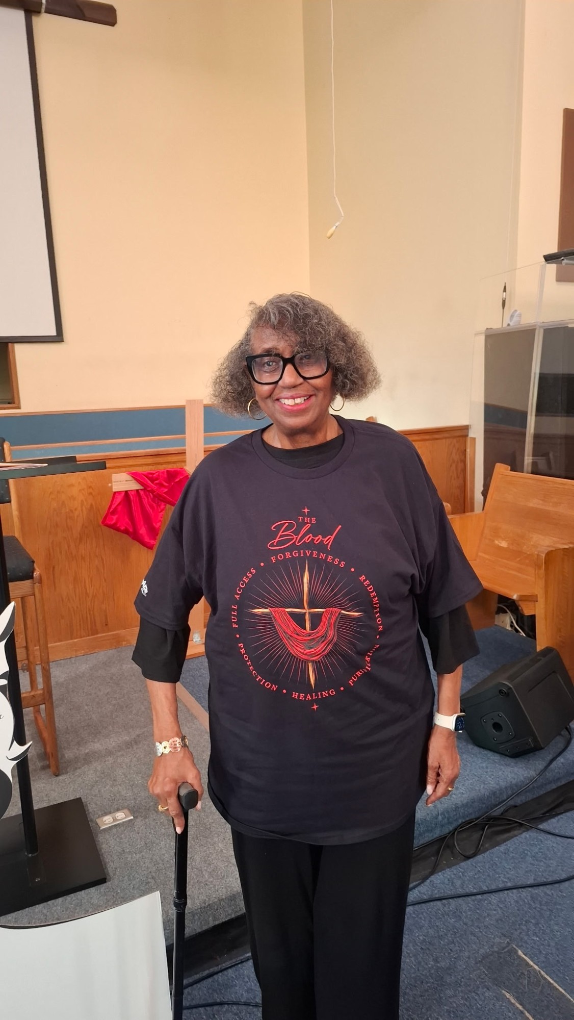 Evangelist Michelle Stewart wearing "The Blood" tee at a ministry service