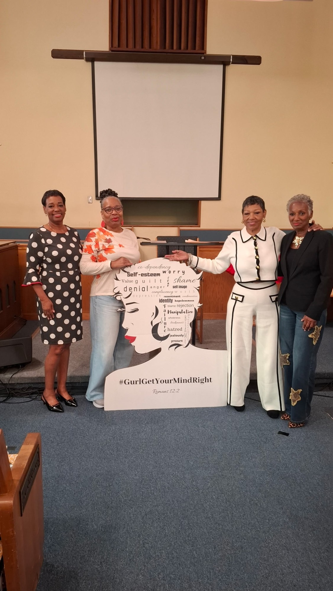 Ministry sisters gathered around the GGYMR standee